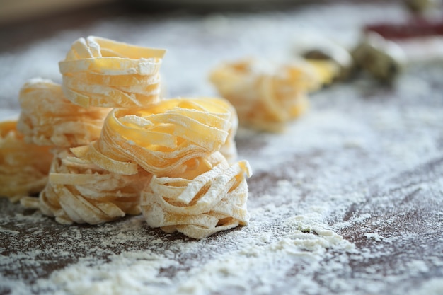 Closeup of process of making cooking homemade pasta.