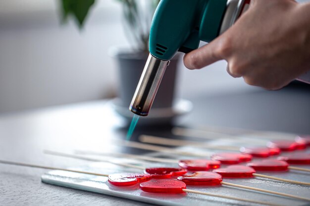 Closeup the process of making heartshaped lollipops