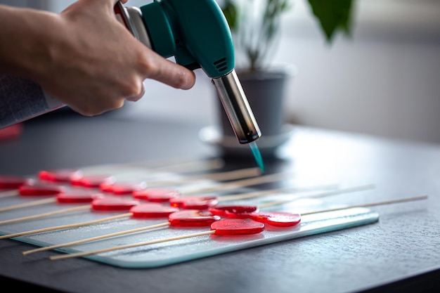 Closeup the process of making heartshaped lollipops