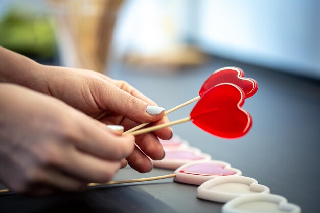 Closeup the process of making heartshaped lollipops