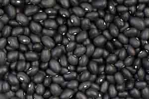 Free photo closeup of raw black beans on the table under the lights