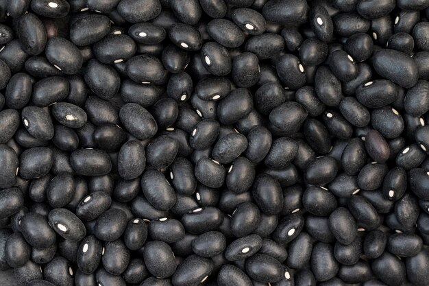 Closeup of raw black beans on the table under the lights