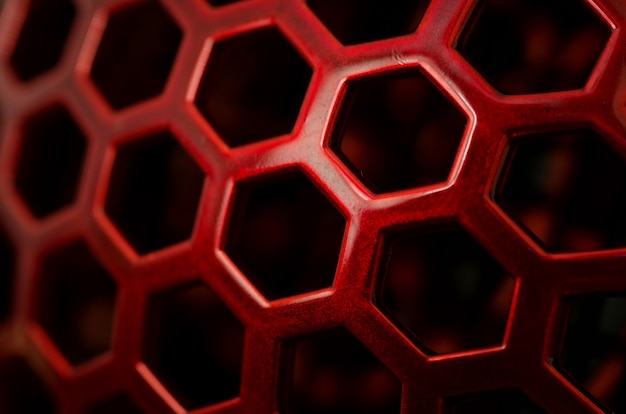 Closeup of a red pattern with hexagon holes