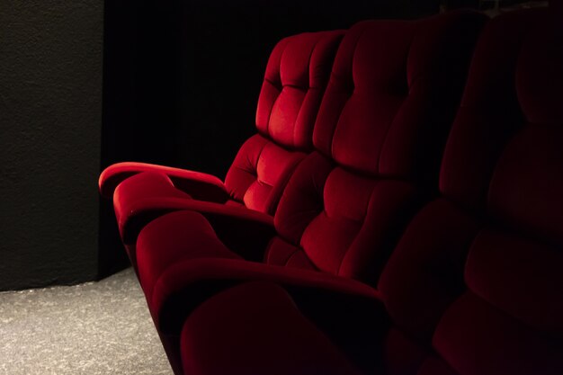 Closeup of red seats under the lights in a cinema in Switzerland