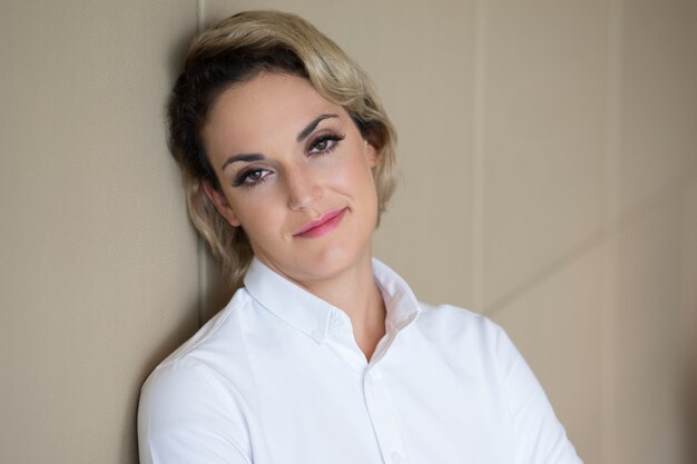 Closeup of Relaxed Content Woman Leaning on Wall