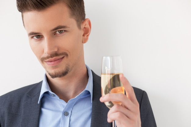 Closeup of Relaxed Young Man Holding Glass of Wine