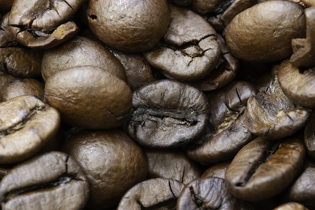 Closeup of roasted coffee beans under the lights with blurred edges