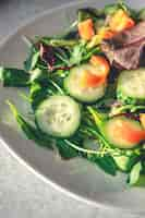 Free photo closeup salad with fresh cucumbers peppers and arugula