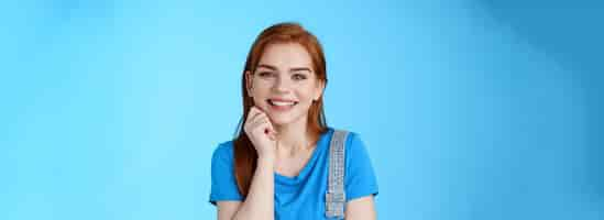 Free photo closeup satisfied tender grinning cute redhead girl look cute lovely camera touch cheek smiling toot