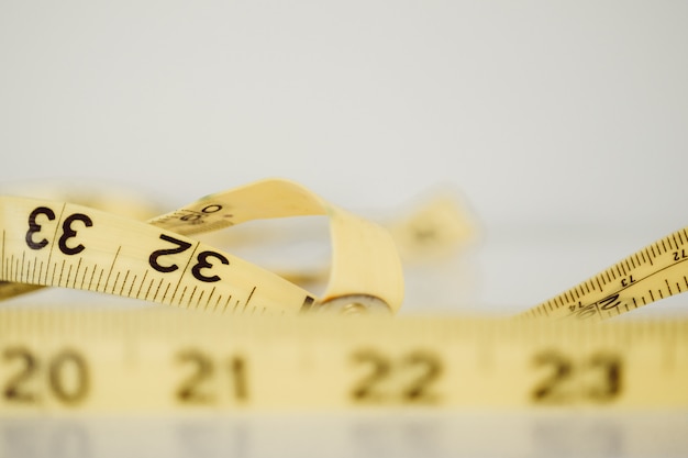 Closeup selective focus photography of a yellow meter on a white surface