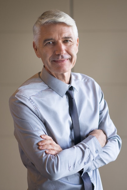 Closeup of Senior Businessman with Arms Crossed