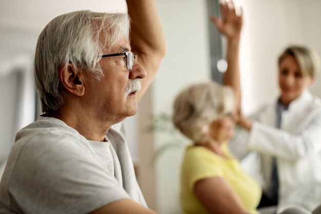 Closeup of senior man having exercise class at home