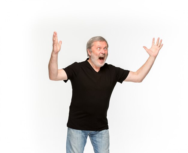 Closeup of senior man's body in empty black t-shirt isolated on white background. 