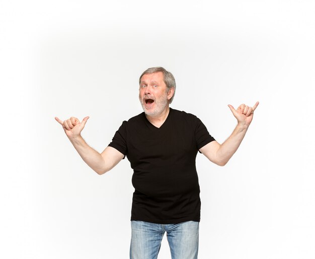 Closeup of senior man's body in empty black t-shirt isolated on white background. 