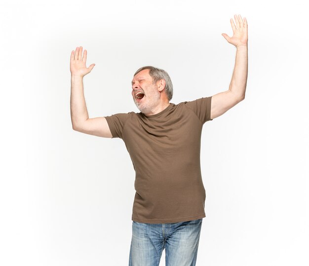 Closeup of senior man's body in empty brown t-shirt isolated on white space. Mock up for disign concept