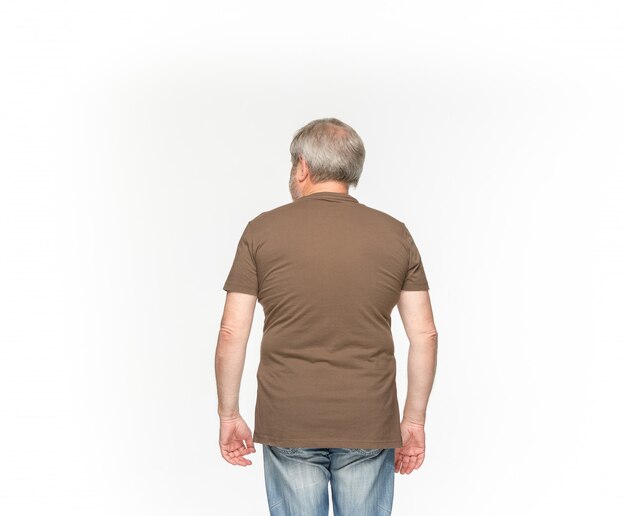 Closeup of senior man's body in empty brown t-shirt on white.