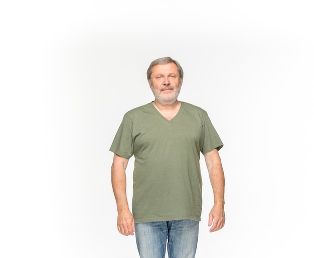 Closeup of senior man's body in empty green t-shirt isolated on white background. Mock up for disign concept