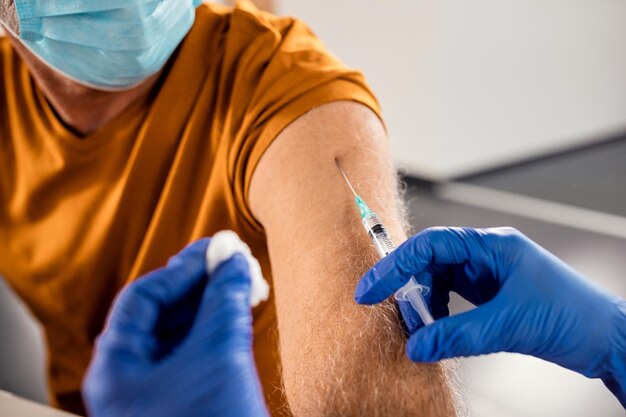 Closeup of senior patient getting vaccinated due to COVID19 pandemic