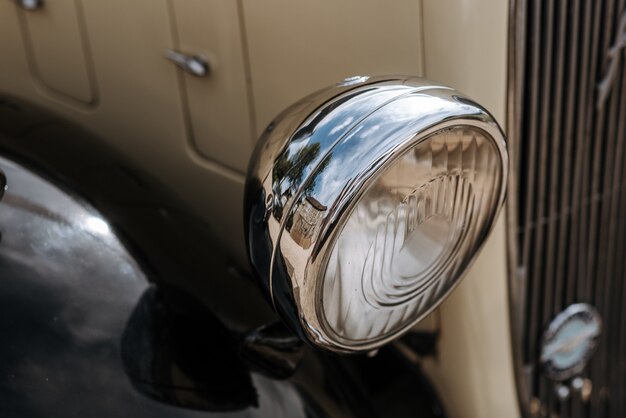 Closeup shot of an antique white car headlight