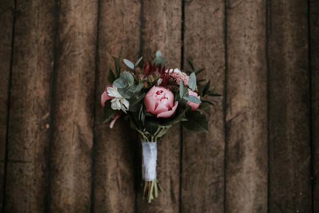 Closeup shot of a beautiful flower bouquet on a wooden surface