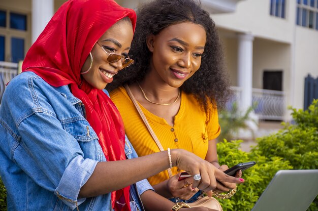 Closeup shot of beautiful young ladies using a laptop