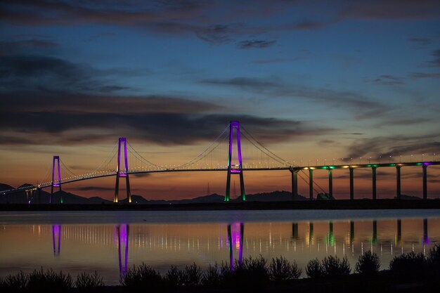 Closeup shot of a big bridge in night colors with reflection in the river in South Korea