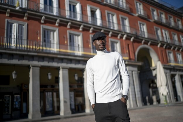 Closeup shot of a black man wearing a hat and a turtleneck