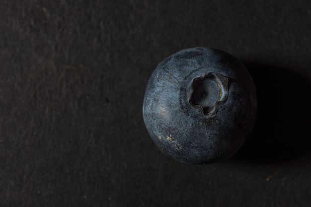 Closeup shot of blueberry on a black background