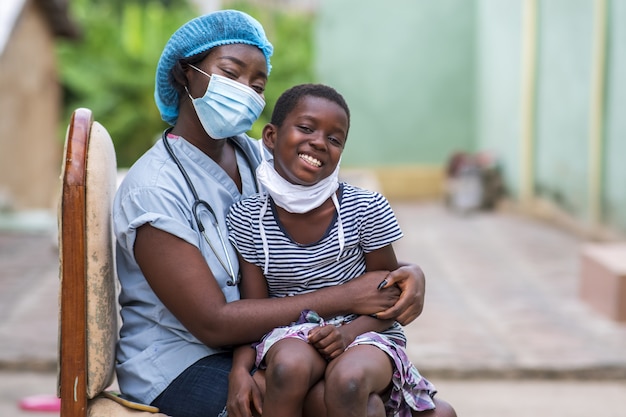 Free photo closeup shot of a boy and a doctor wearing sanitary masks