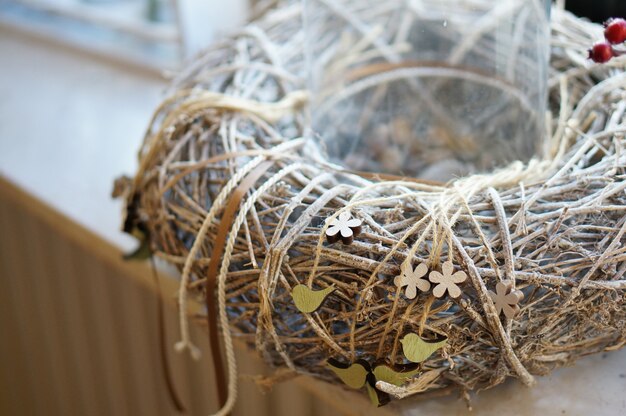 Closeup shot of a branch wreath with ropes wrapped around it