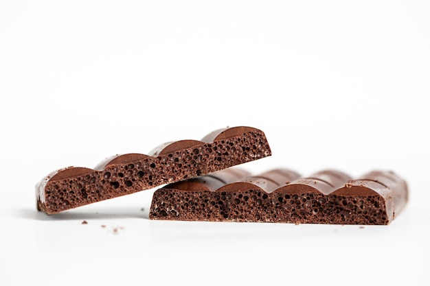 Closeup shot of bubble chocolate pieces isolated on a white surface