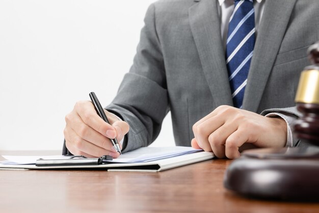 Closeup shot of a businessman signing some official papers