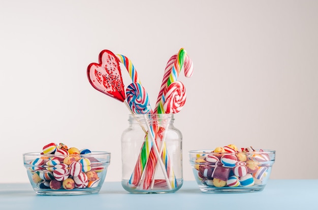 Closeup shot of candy canes and other candies in glass jars - perfect for a cool wallpaper