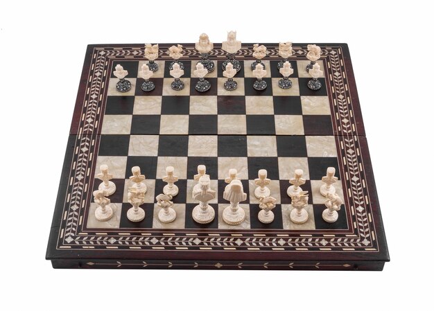 Closeup shot of a chess board with chess wooden pieces isolated on a white