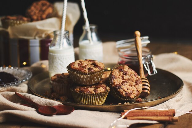 Closeup shot of chocolate muffins with honey and milk
