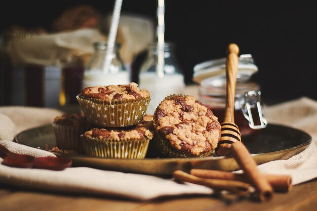 Closeup shot of chocolate muffins with honey and milk