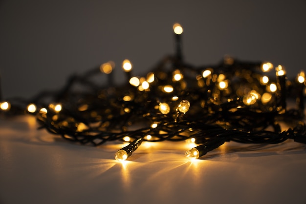 Closeup shot of Christmas lights on a white surface