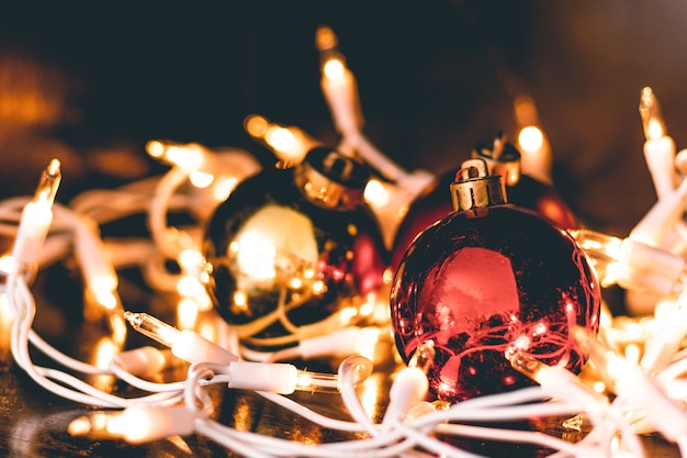 Free photo a closeup shot of christmas ornaments surrounded by tree lights