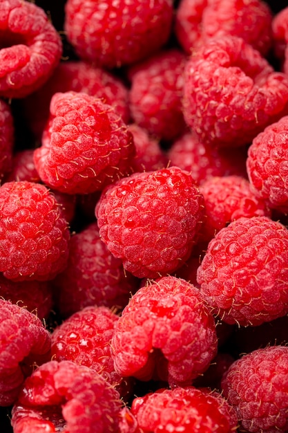 Closeup shot of cute fresh raspberries one on another