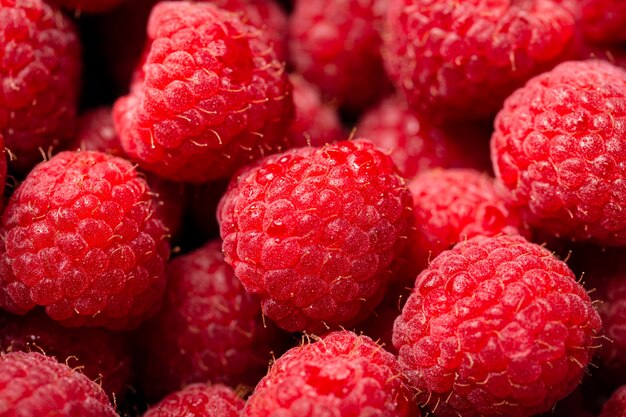 Closeup shot of cute fresh raspberries one on another