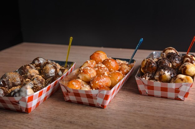 Closeup shot of delicious fried doughnuts with caramel and chocolate sauce