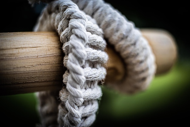 Closeup shot of details on a thick rope around a wooden pole