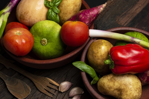 Closeup shot of different fresh vegetables in wooden bowls