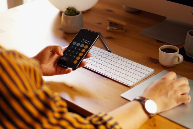 Closeup shot of an entrepreneur working from home and doing calculations