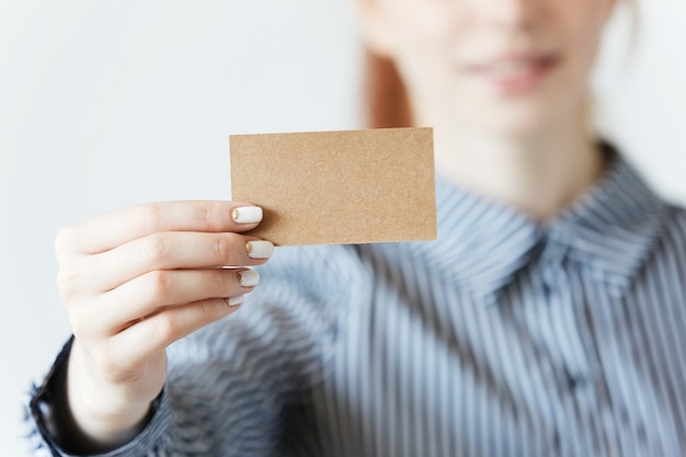 Closeup shot of female hands holding a blank business card