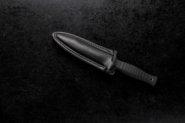 Снимок крупным планом фиксированного острого ножа на черном