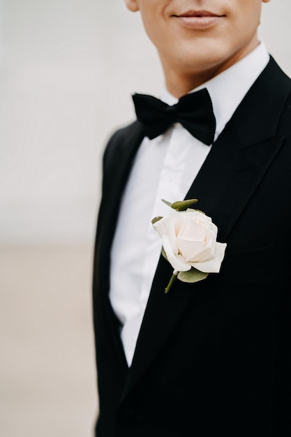 Closeup shot of a flower in a Caucasian white groom pocket with a blurry back ground in Lithuania