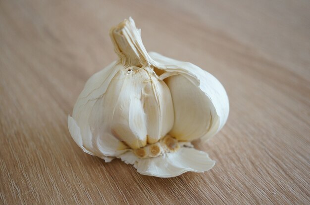 Closeup shot of a fresh garlic on a wooden surface