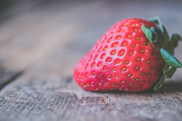 Closeup shot of fresh ripe strawberries on a wooden table