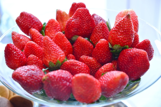 Closeup shot of fresh strawberries in a glass plate